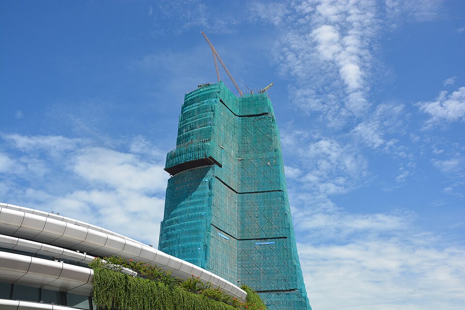 High-rise tower under construction with safety netting